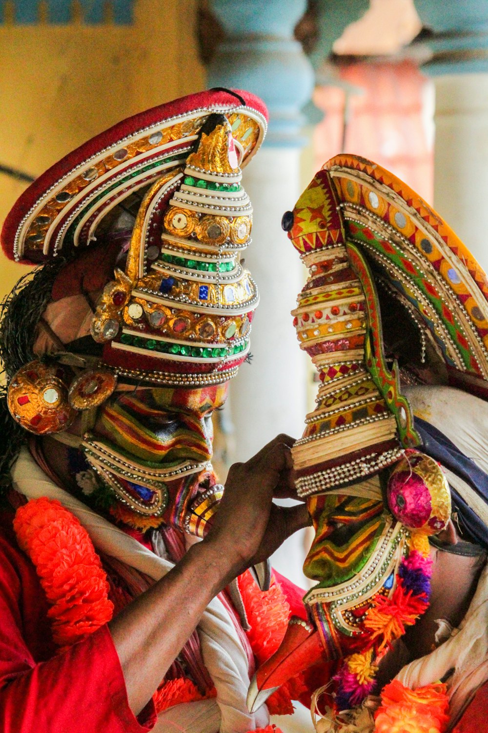 person wearing gold and red headdress