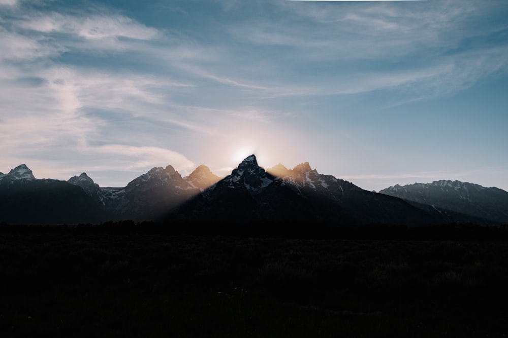 silhouette of mountains under blue sky during daytime