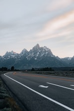 gray concrete road near mountain range