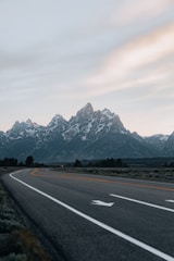 gray concrete road near mountain range