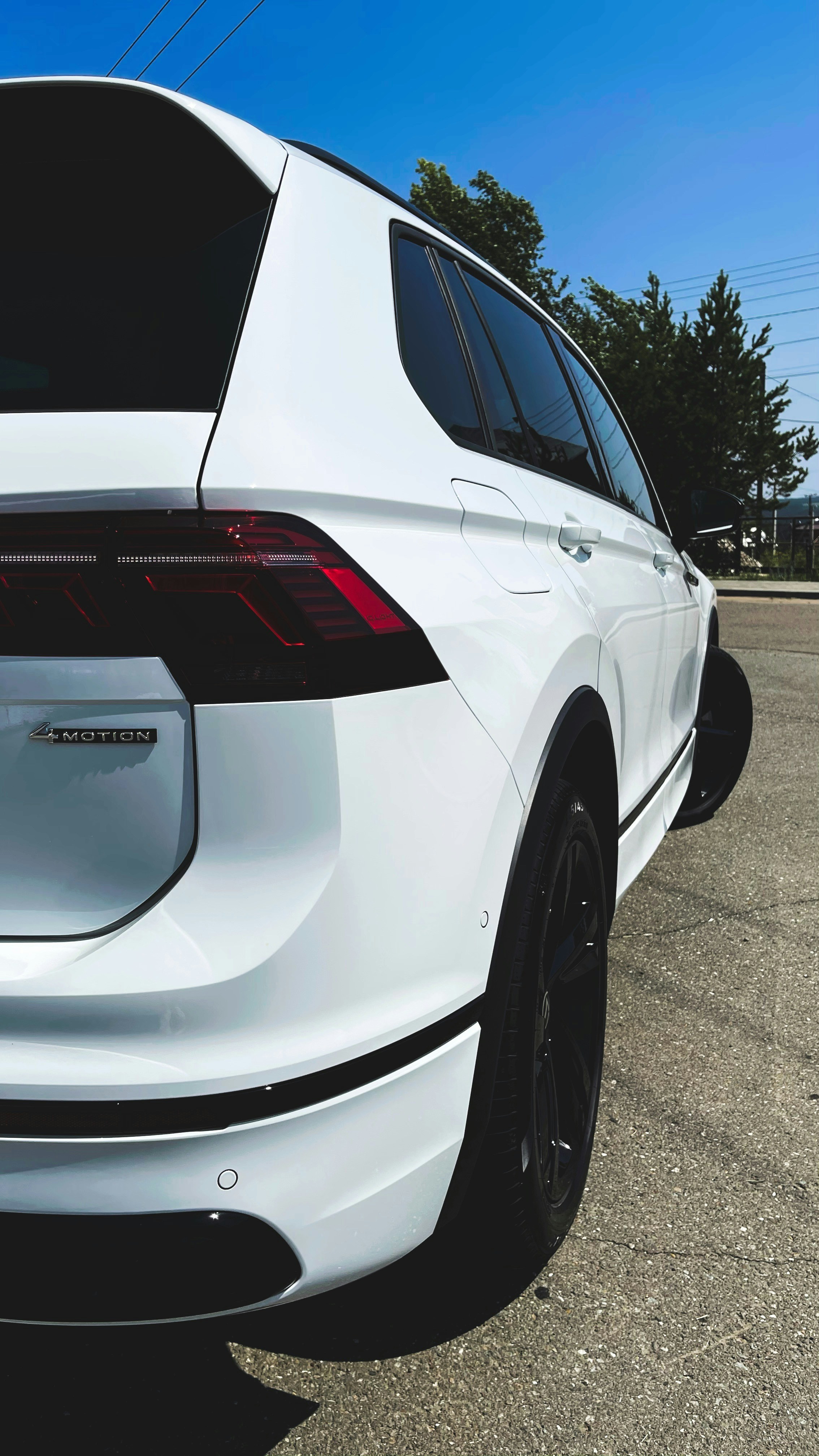 White Volkswagen Tiguan SUV in parking lot