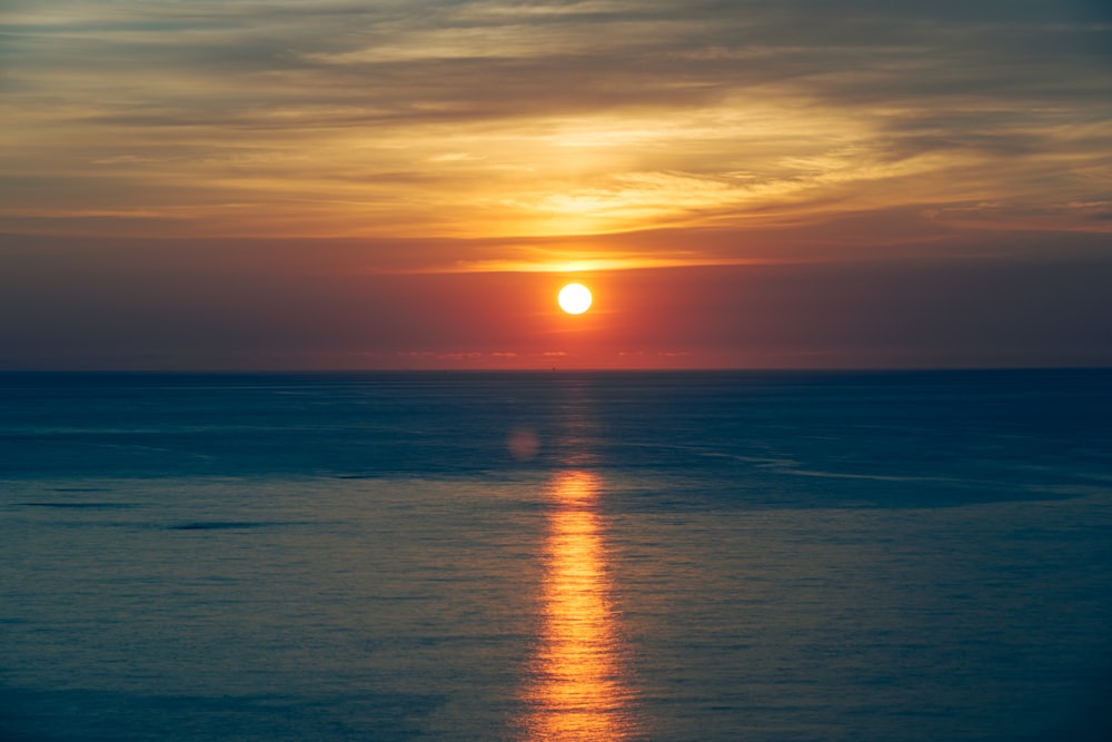 body of water during sunset