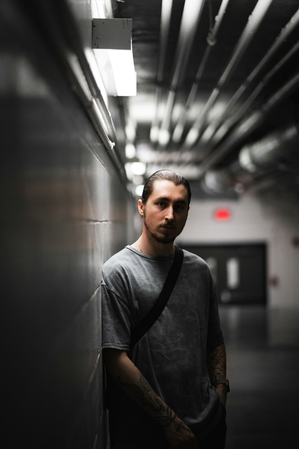 man in gray crew neck t-shirt standing in hallway