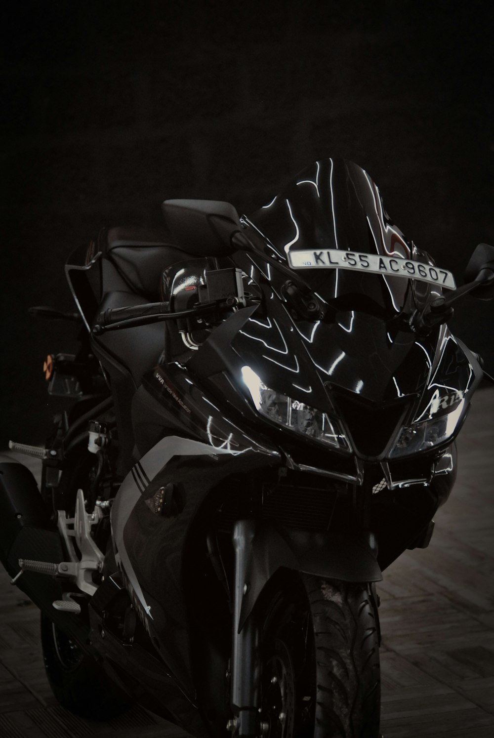 a black motorcycle parked in a dark room