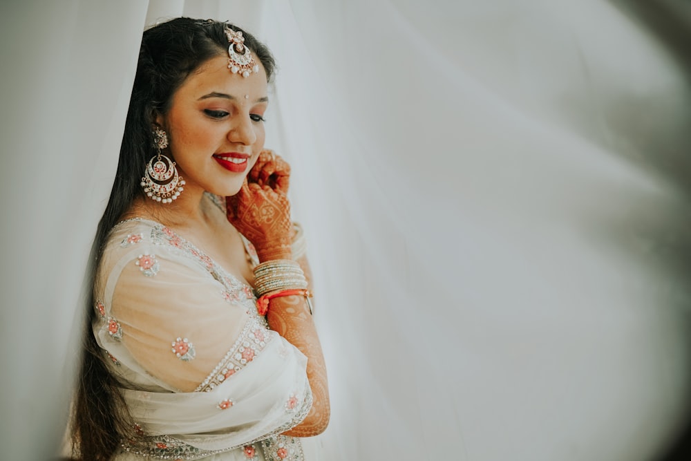 woman in white floral dress smiling