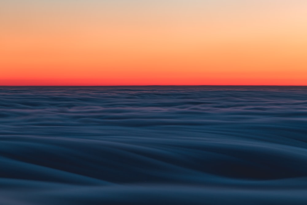 body of water during sunset