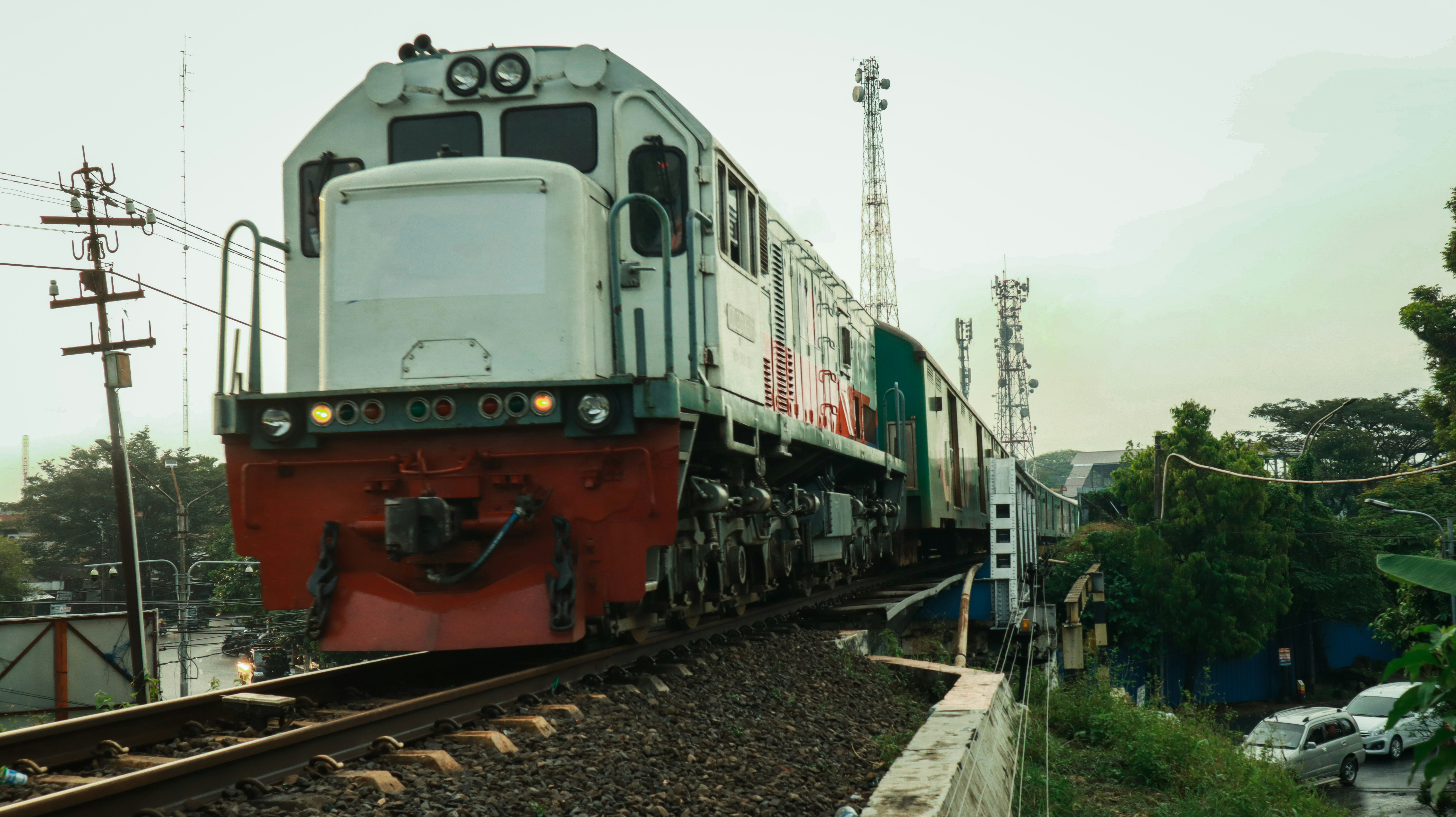 red and white train on rail tracks during daytime