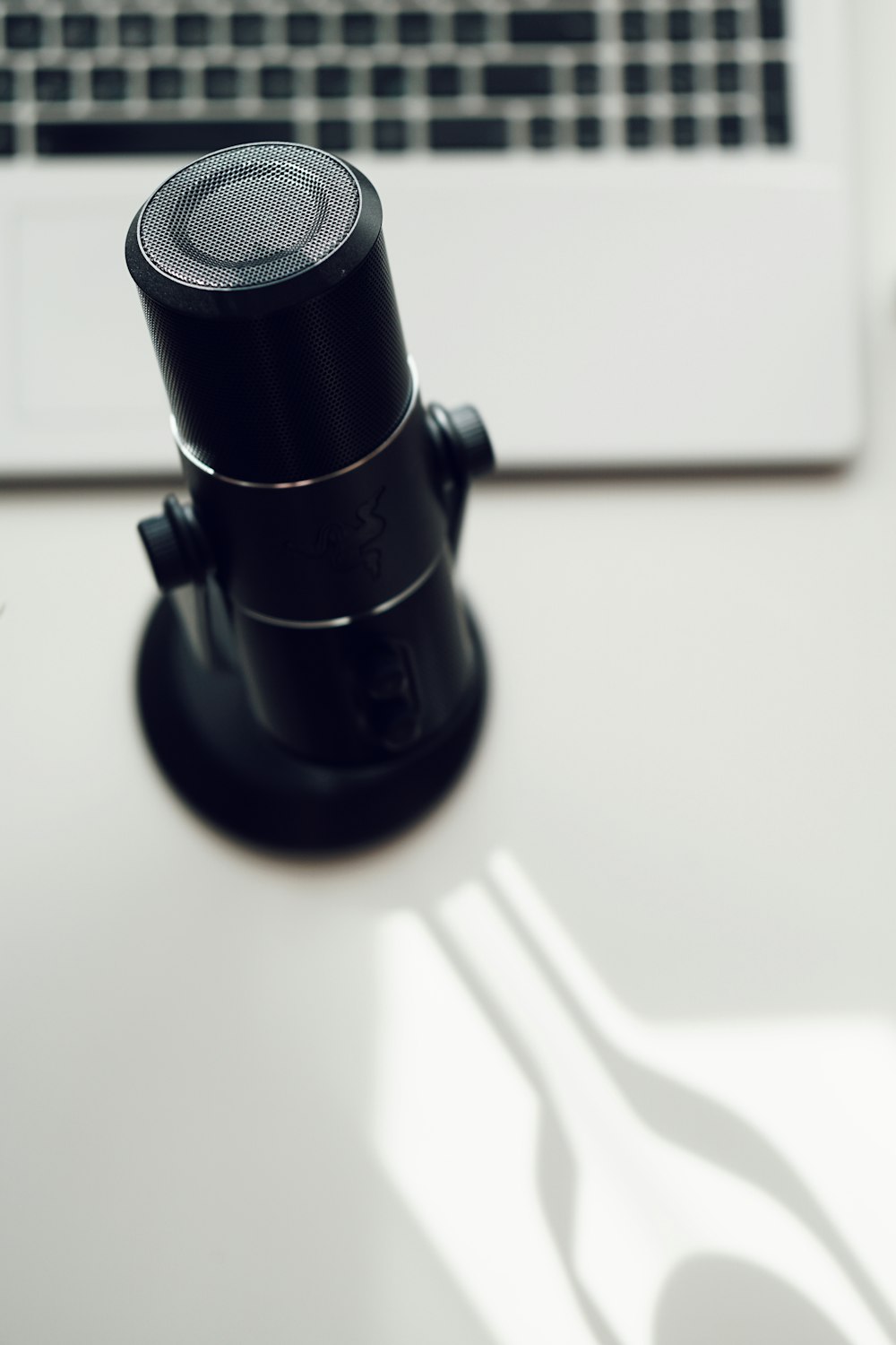 black and silver microphone on white table