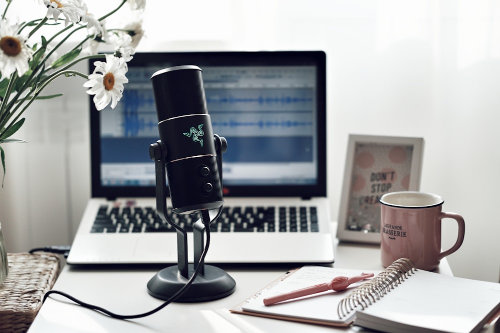 black microphone on white paper