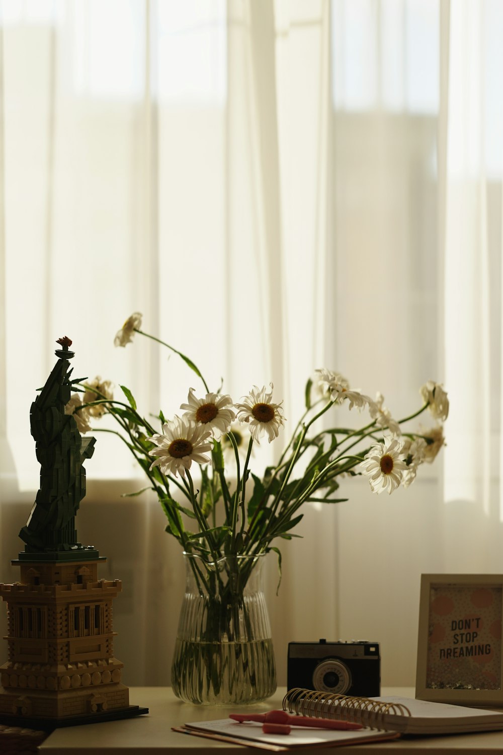 white flowers in clear glass vase