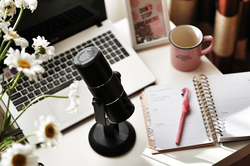 black and silver camera lens on white paper