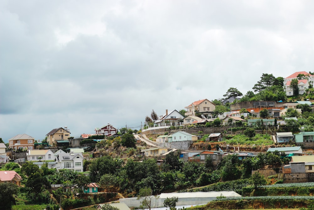 white and brown houses under white cloudy sky during daytime