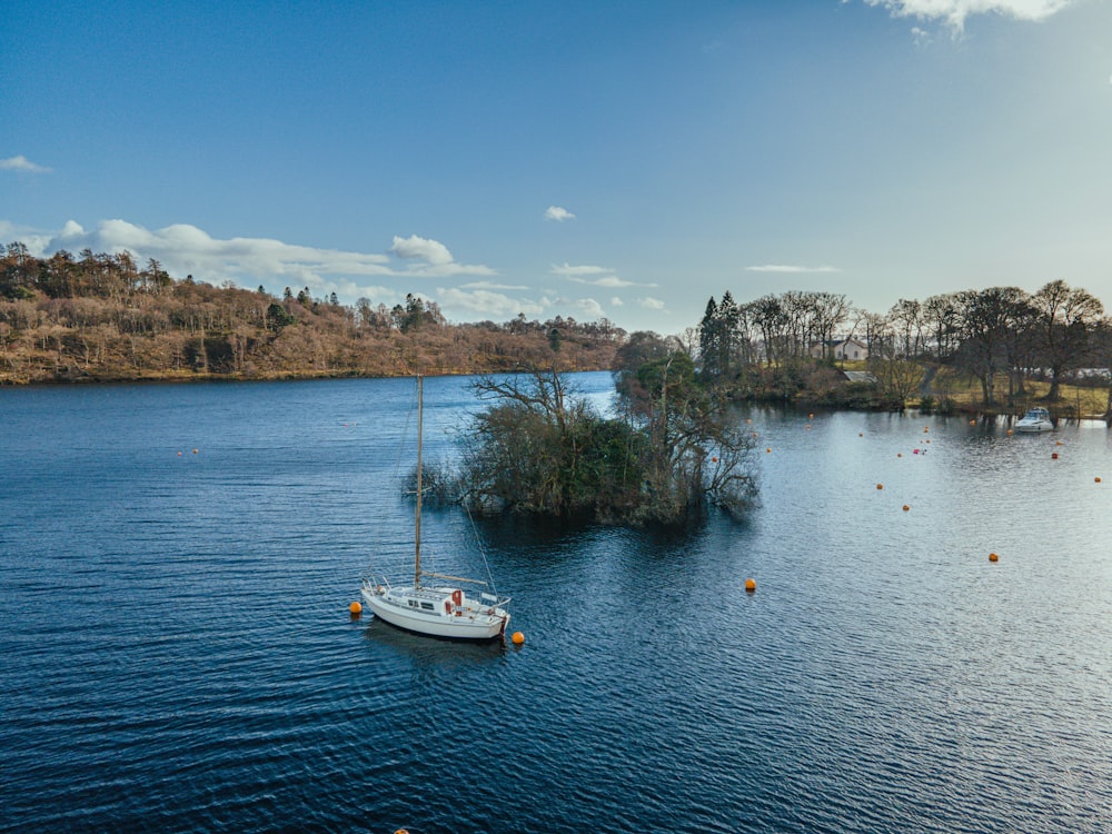 white boat on water during daytime