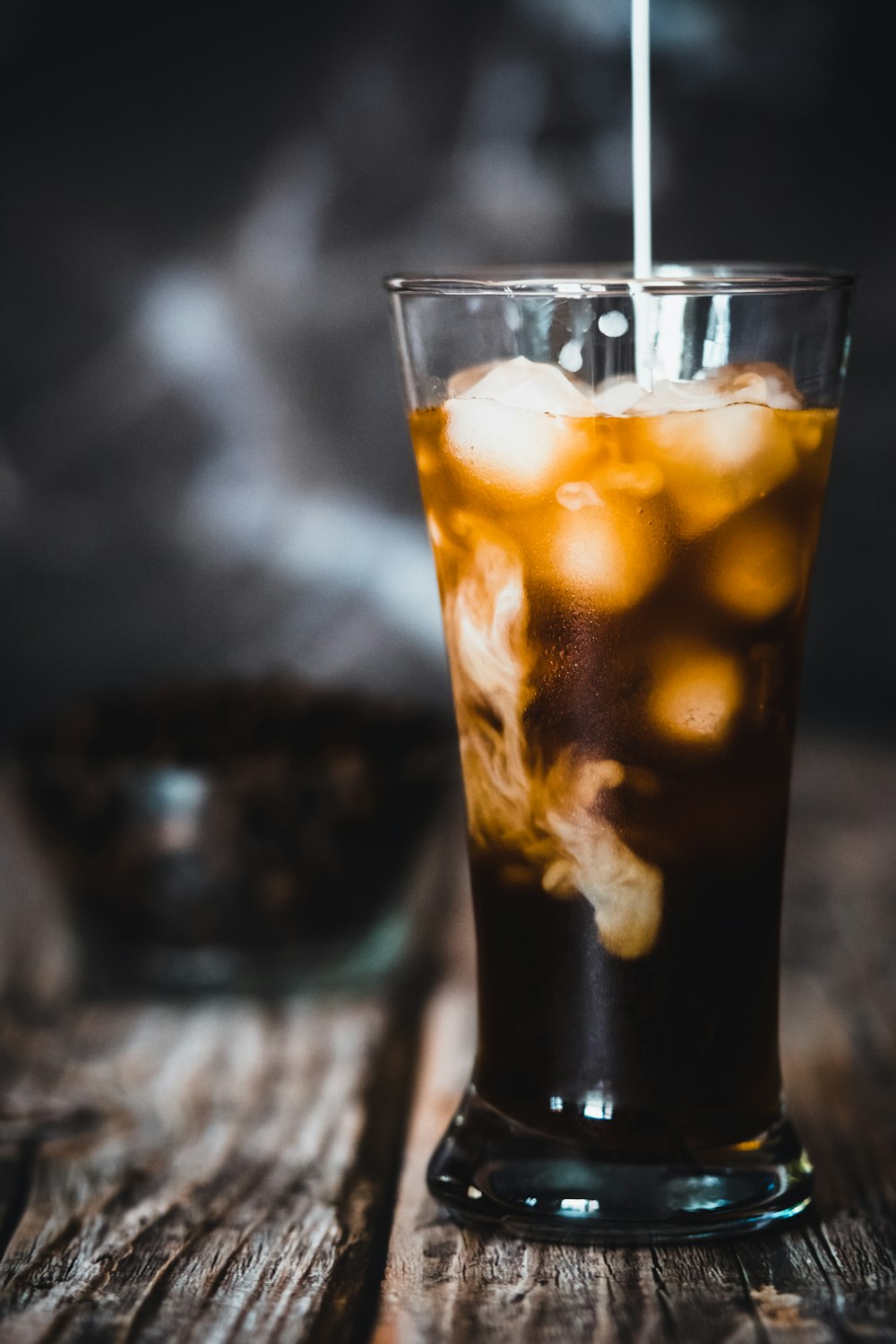 clear drinking glass with black liquid