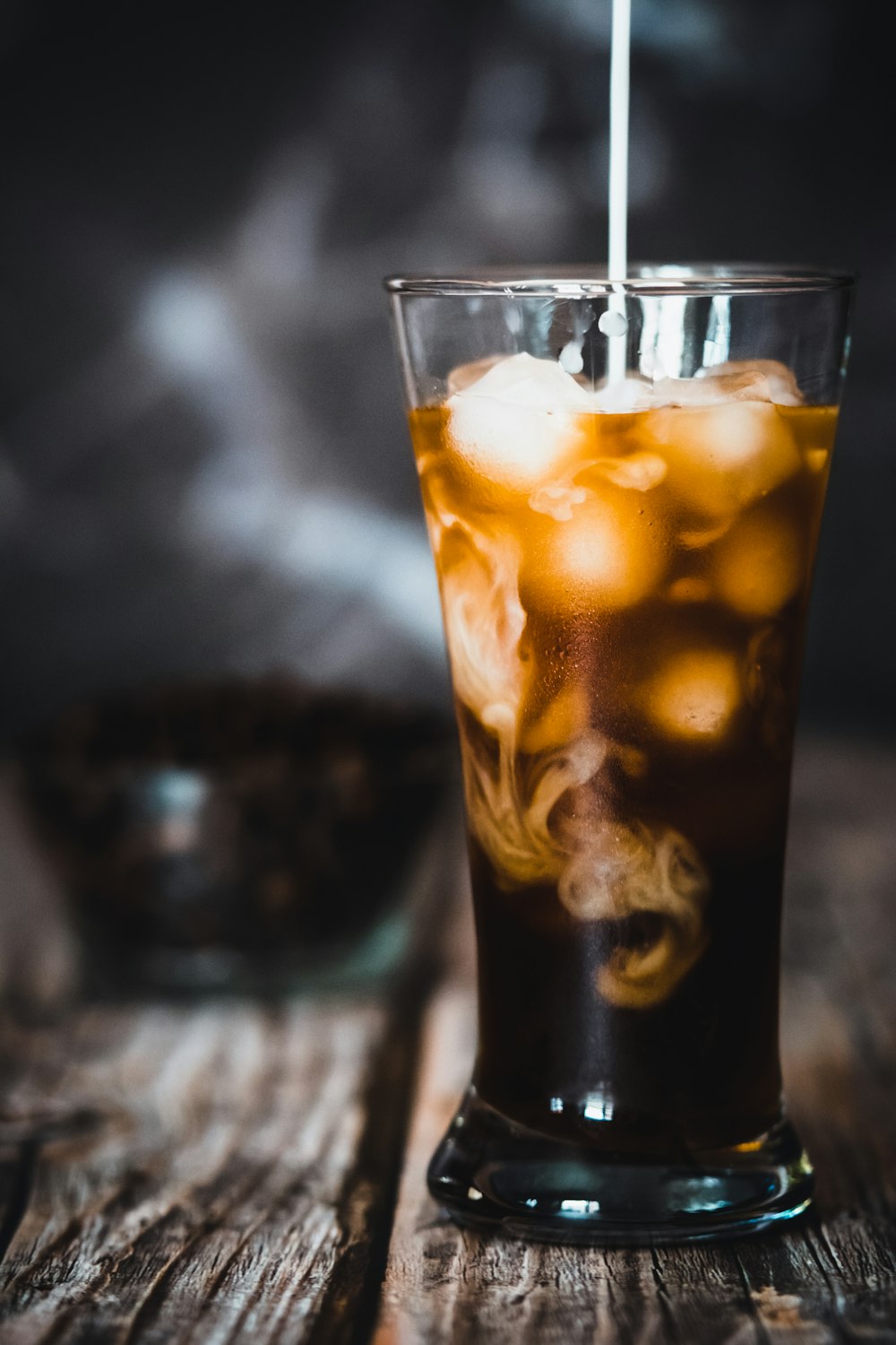 clear drinking glass with brown liquid