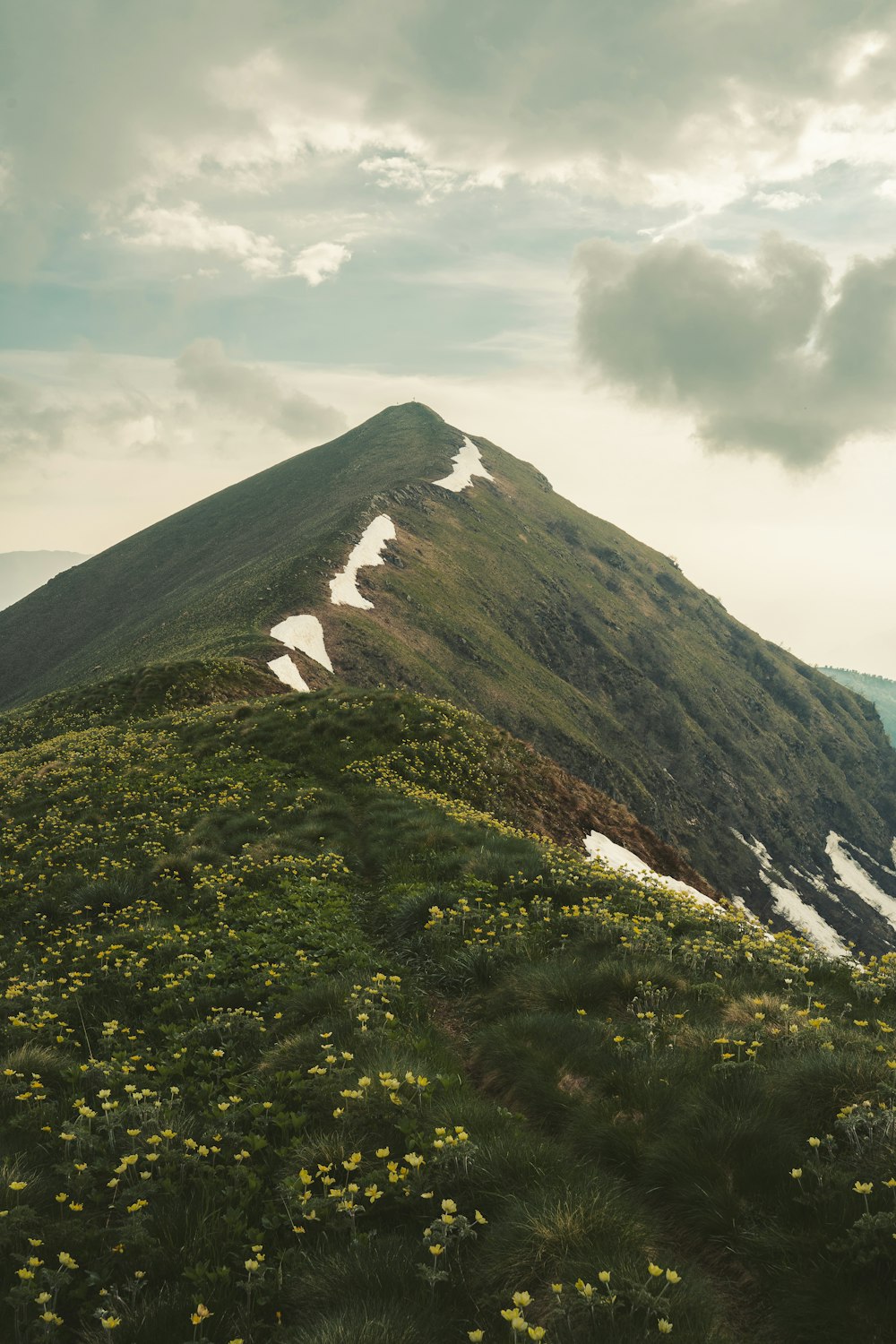 green and brown mountain under white clouds during daytime