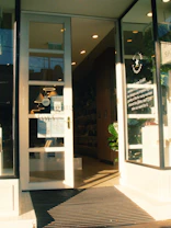 Bright and clean commercial storefront with customers entering.
