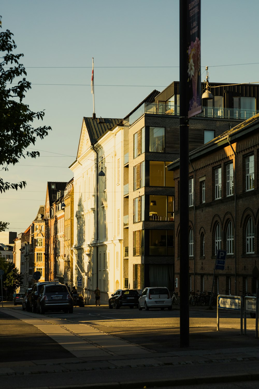 cars parked beside brown concrete building during daytime