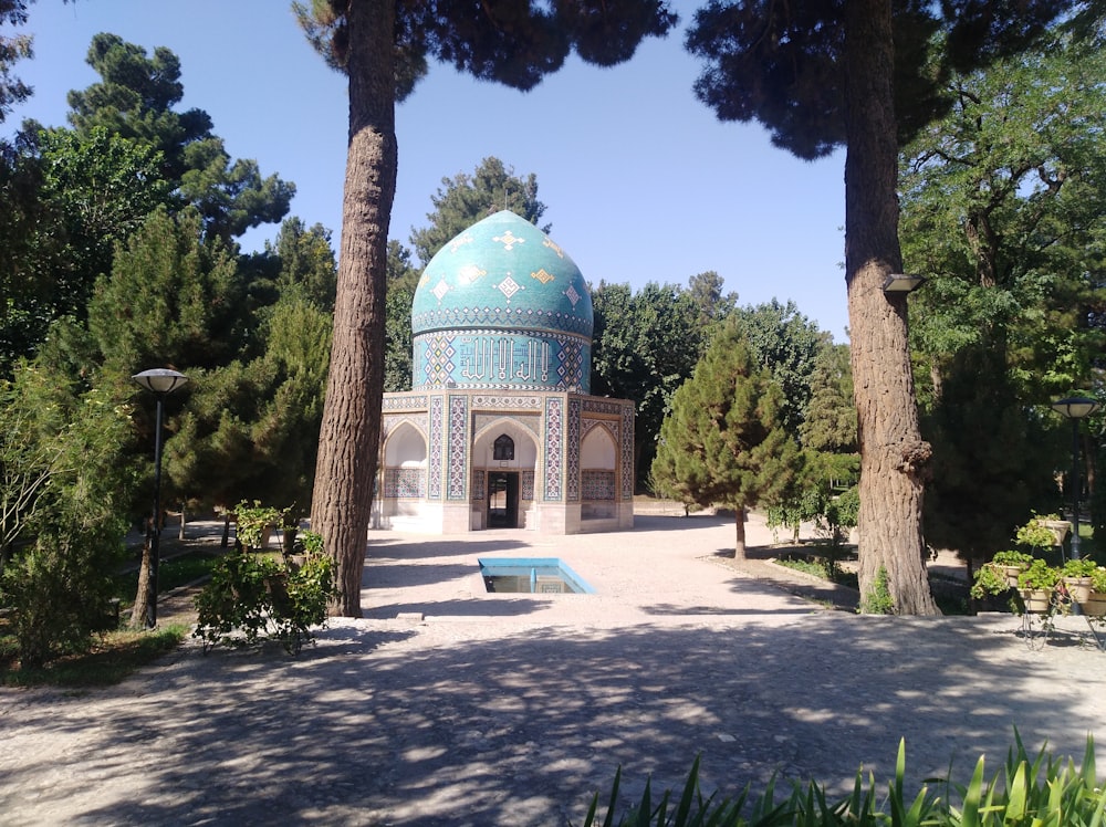 green and white dome building surrounded by trees