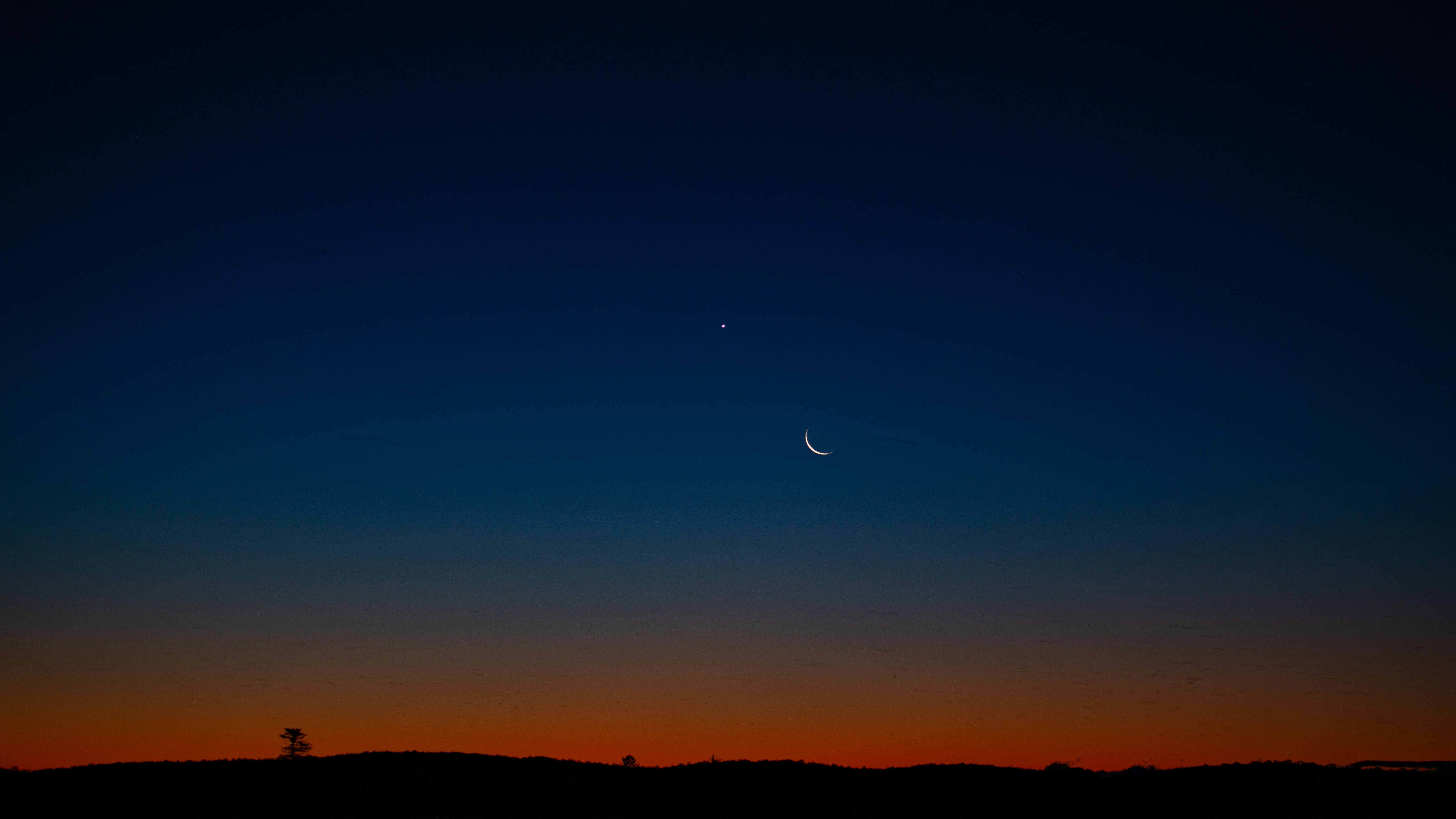 silhouette of mountain under blue sky during daytime