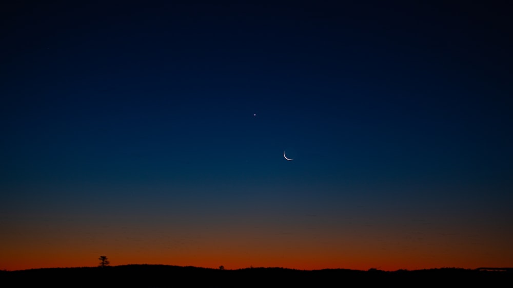 silhouette of mountain under blue sky during daytime