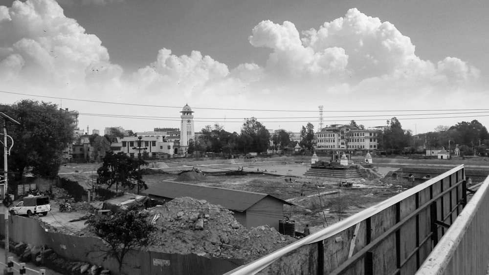 grayscale photo of city buildings under cloudy sky