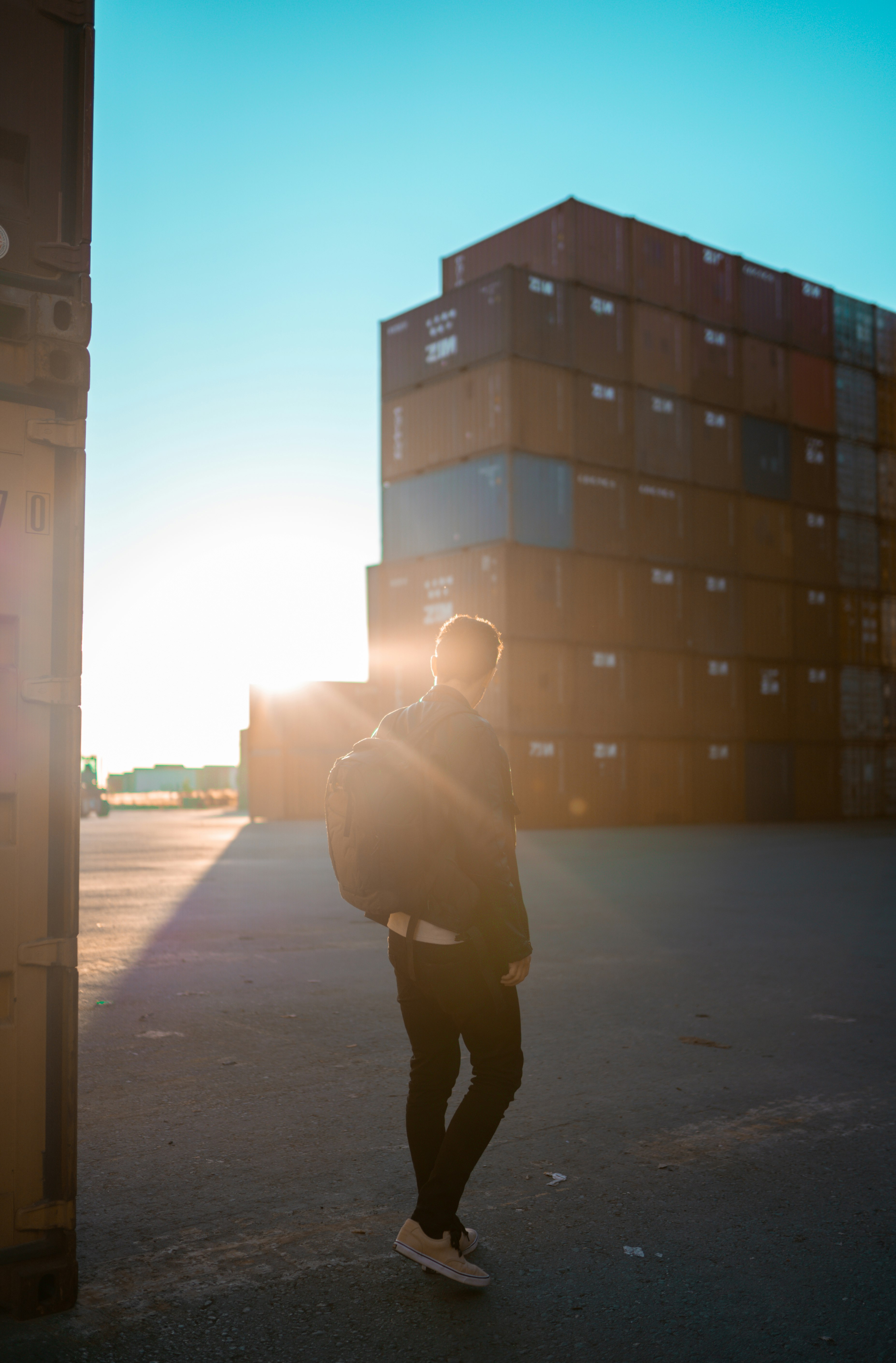 man in brown jacket walking on sidewalk during daytime