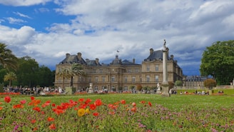 Guests enjoying a peaceful evening in a lush garden surrounded by heritage architecture.