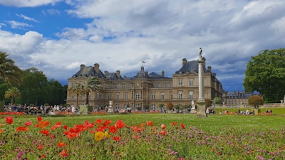 Guests enjoying a peaceful evening in a lush garden surrounded by heritage architecture.