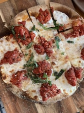 A delicious Margherita pizza with fresh basil on top.