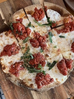 A deliciously topped wood-fired pizza with melted cheese and fresh basil.