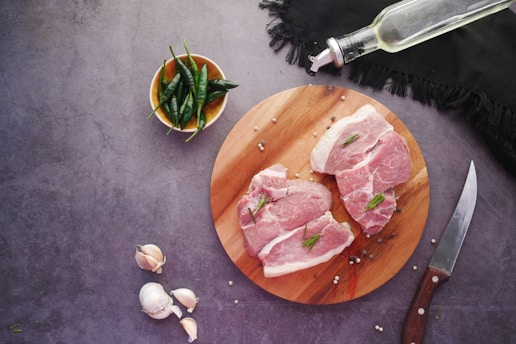 sliced meat on brown wooden chopping board