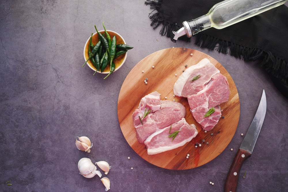 sliced meat on brown wooden chopping board