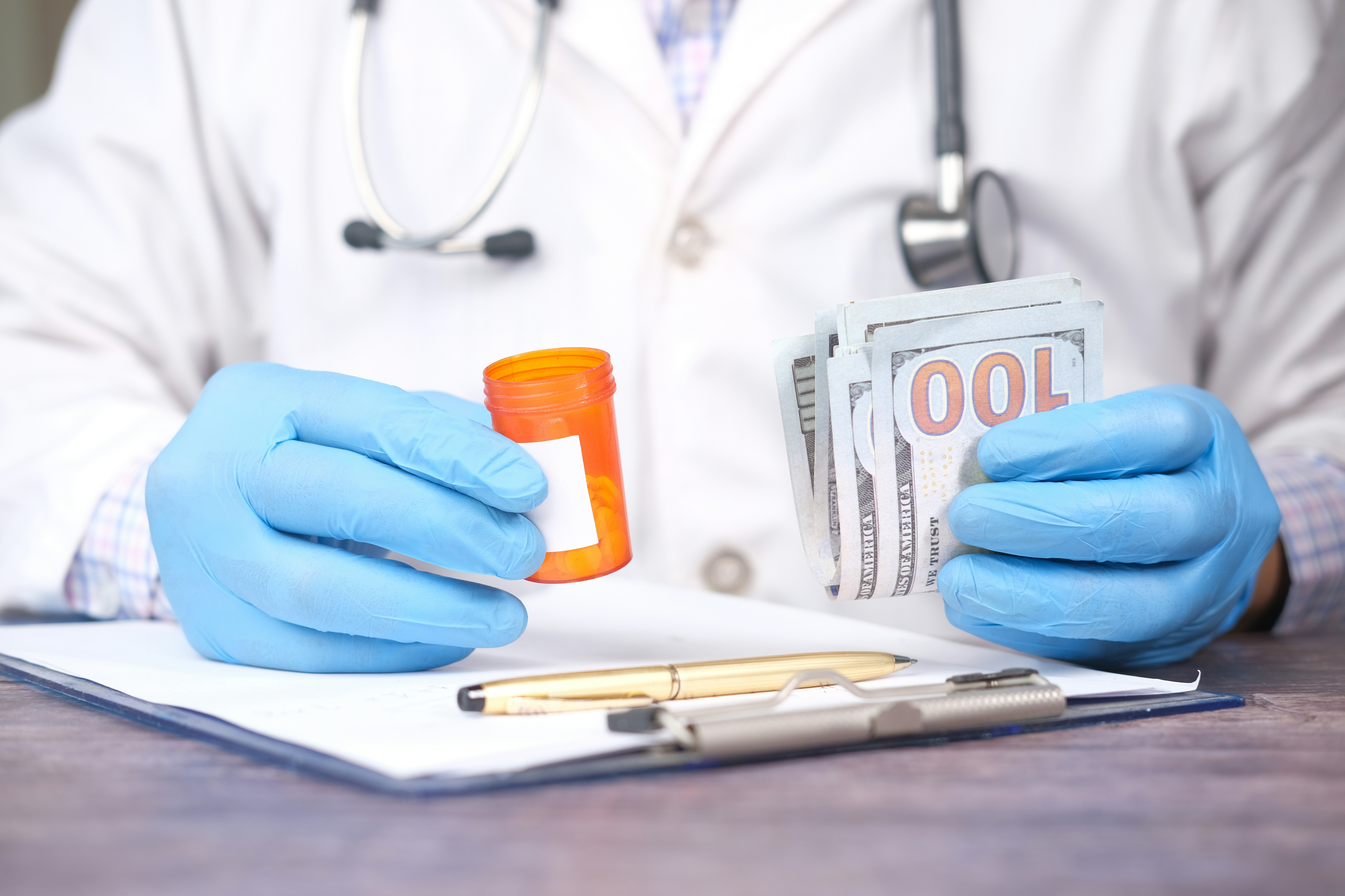 doctor hand in gloves holding us dollar cash,