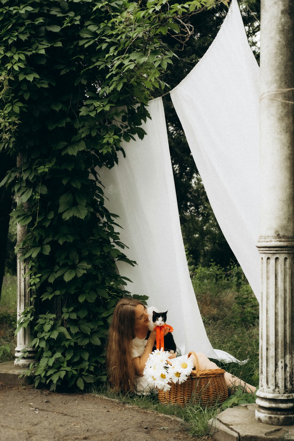 woman in white dress sitting on white textile