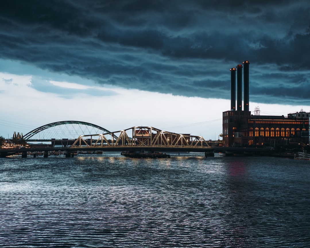 bridge over water under cloudy sky during daytime