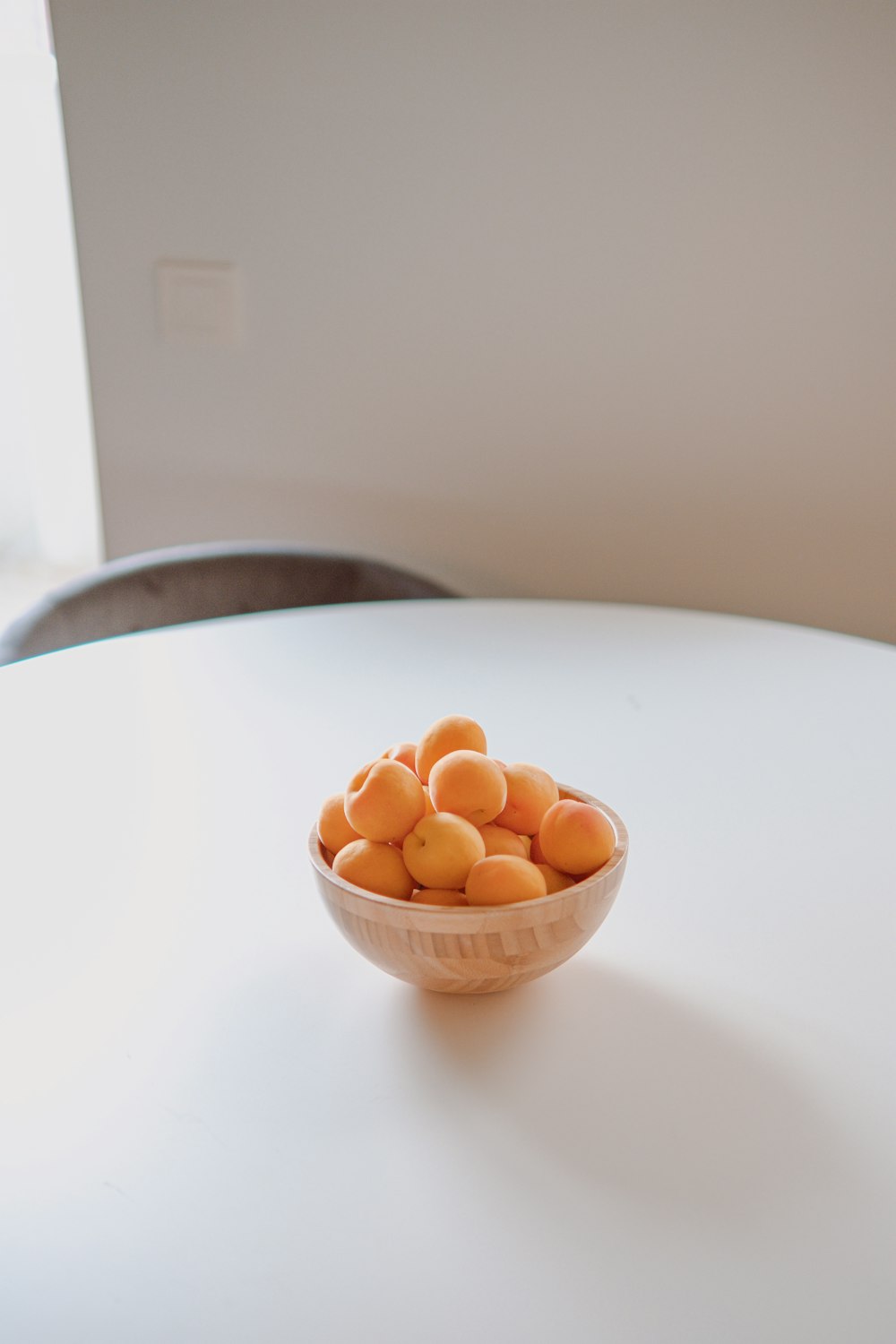 brown round fruit on white ceramic bowl