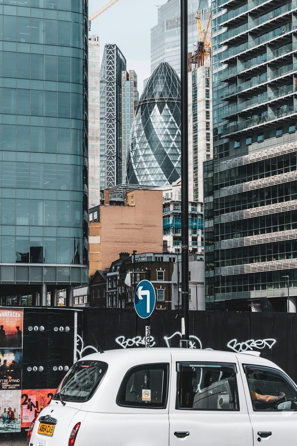 white car parked beside white car during daytime