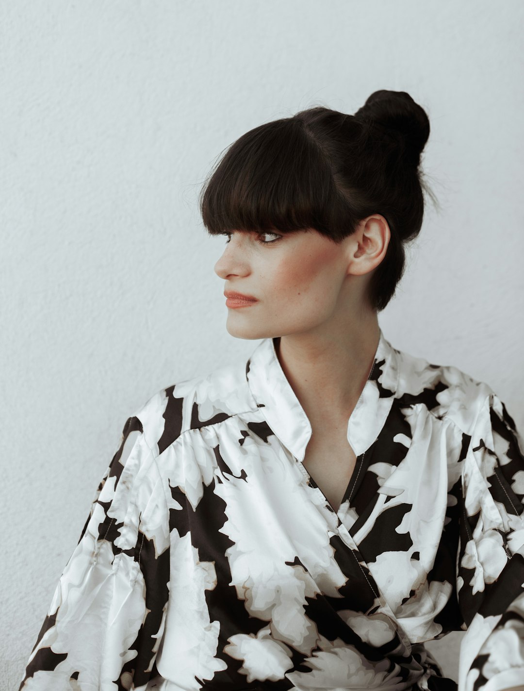 woman in black and white floral collared shirt