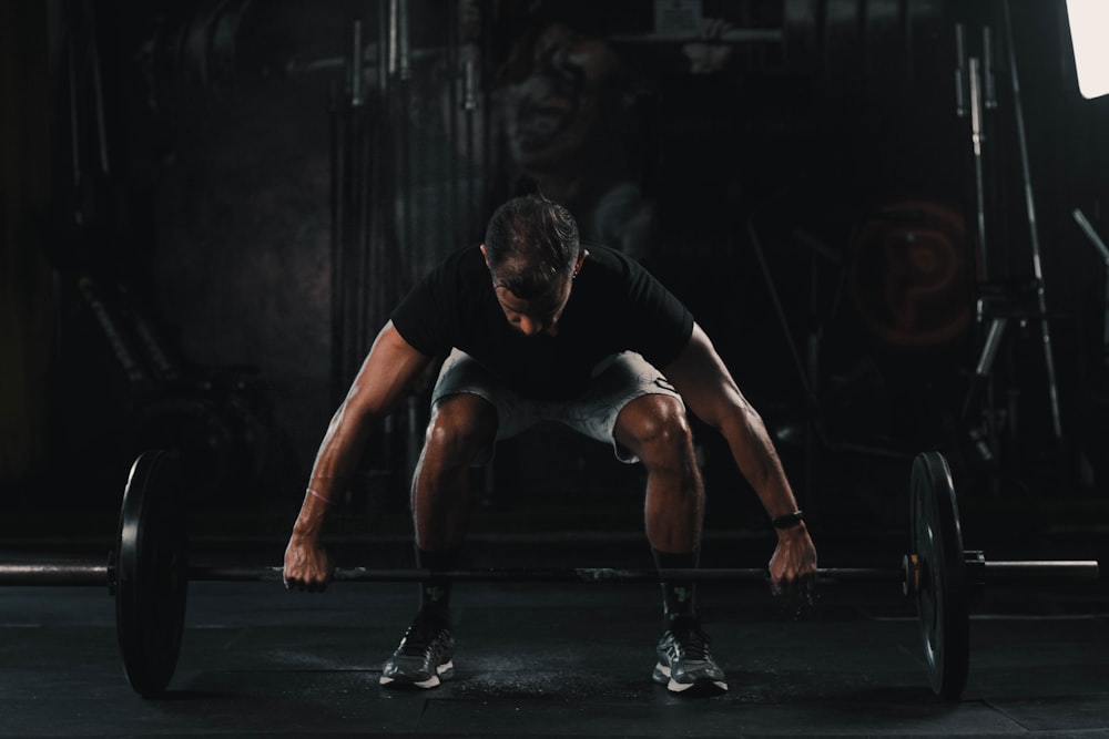 man in black tank top and black shorts doing push up