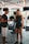 A personal trainer guiding a client through a workout session in a gym.