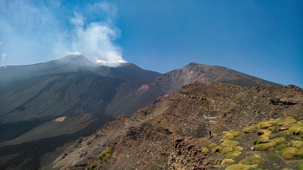 green and brown mountain under blue sky during daytime