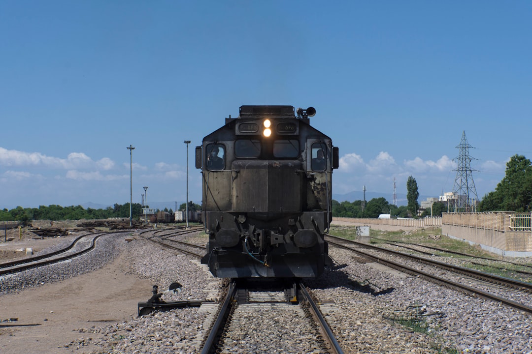 black train on rail road during daytime