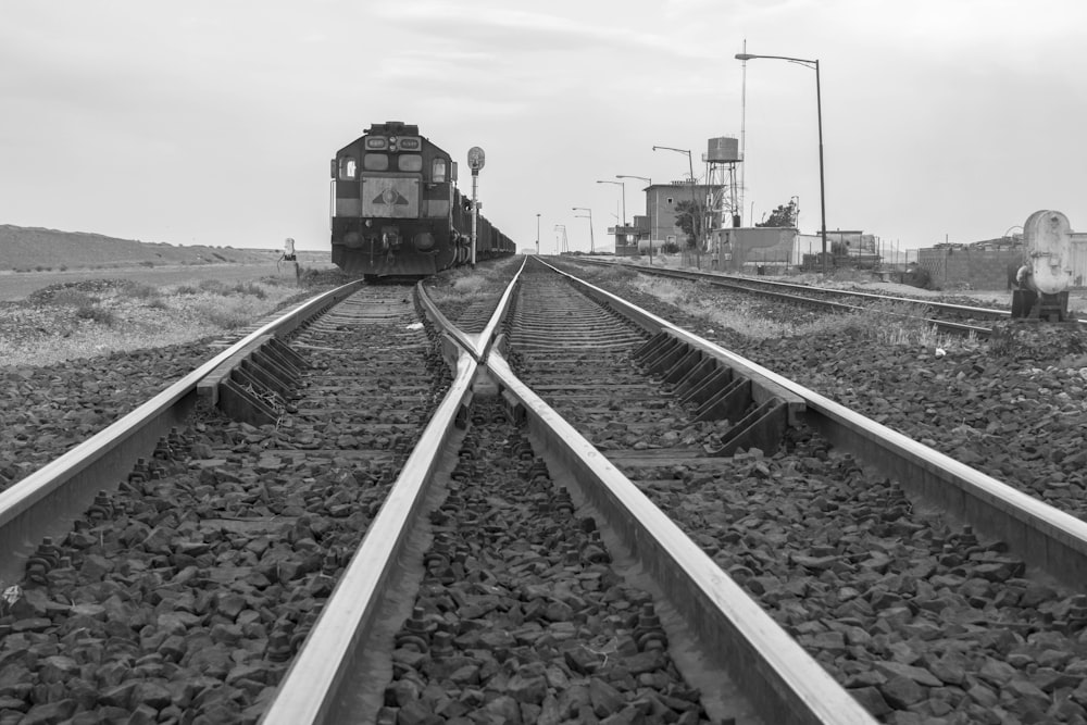 grayscale photo of train on rail tracks