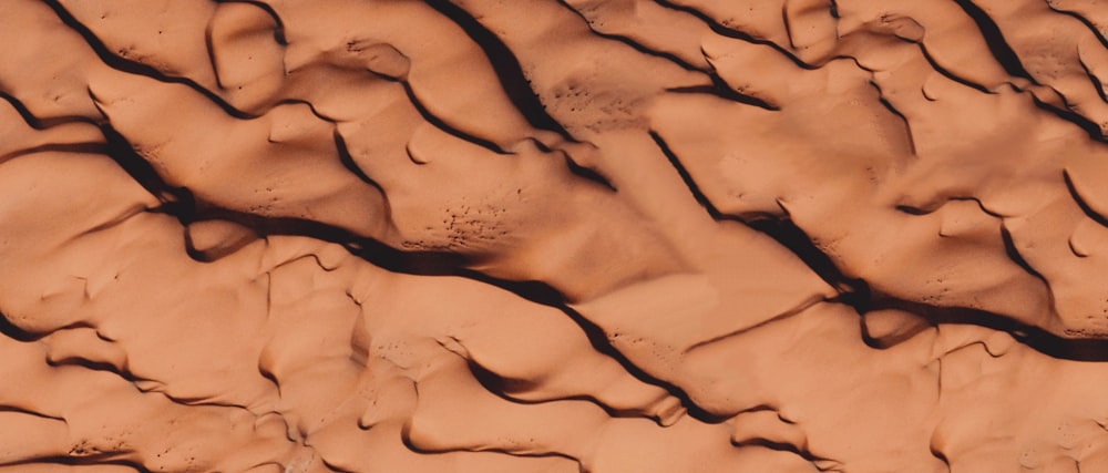 brown sand with footprints during daytime