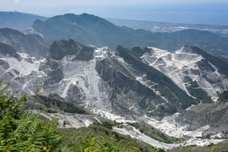 gray and white mountains under white sky during daytime
