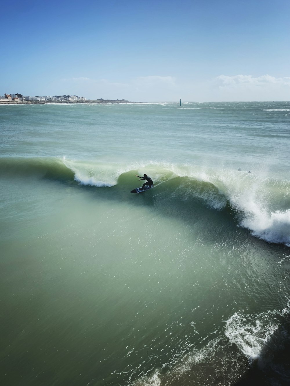 person surfing on sea waves during daytime