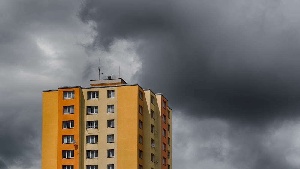 brown and beige concrete building under gray clouds