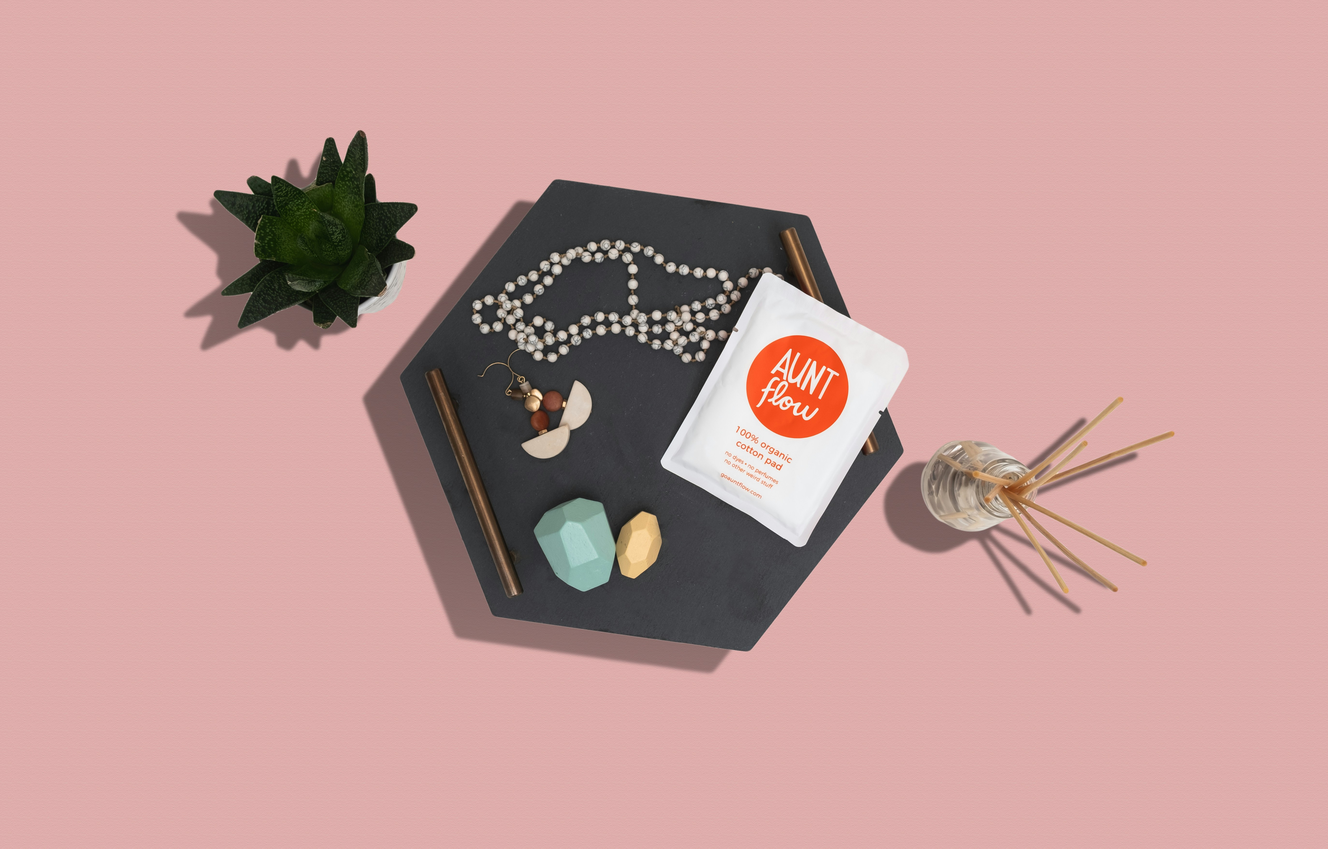 silver and gold beaded necklace on black box