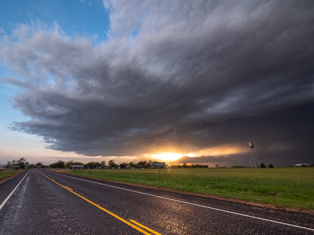 gray concrete road under gray clouds